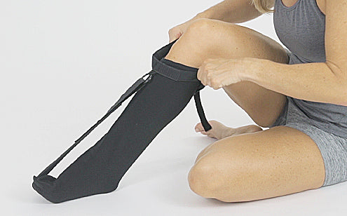 woman putting on plantar fasciitis stretch stock