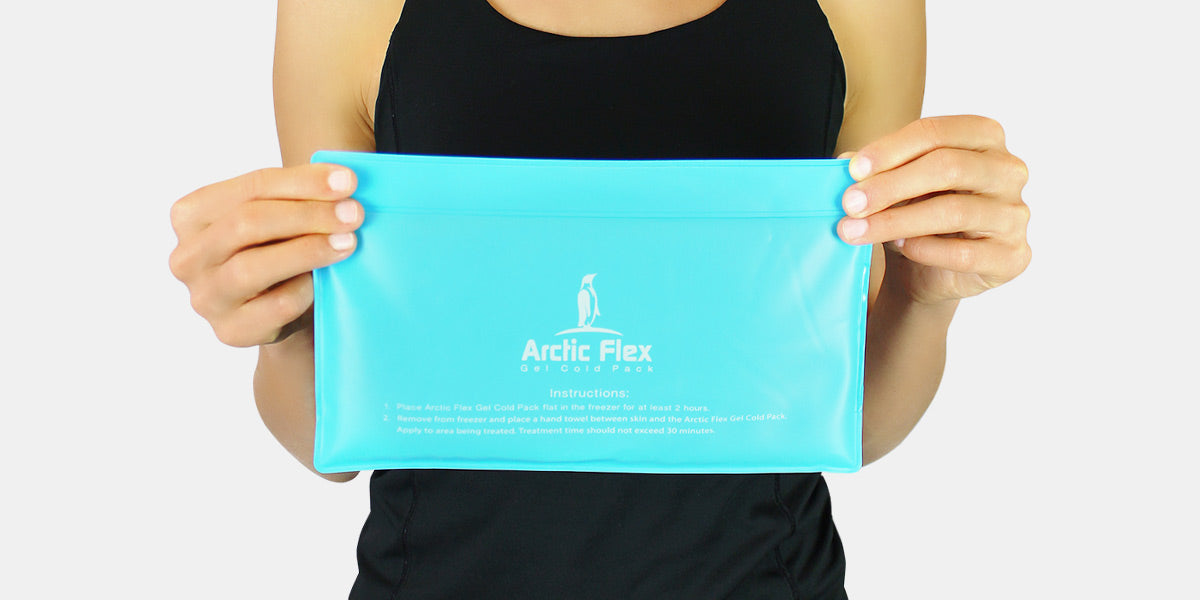 Woman in black holding gel ice pack by arctic flex