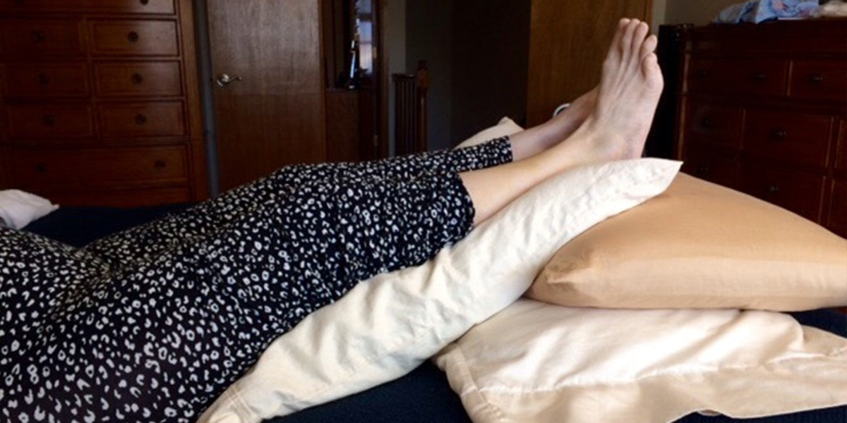 feet and legs elevated on foam mattress