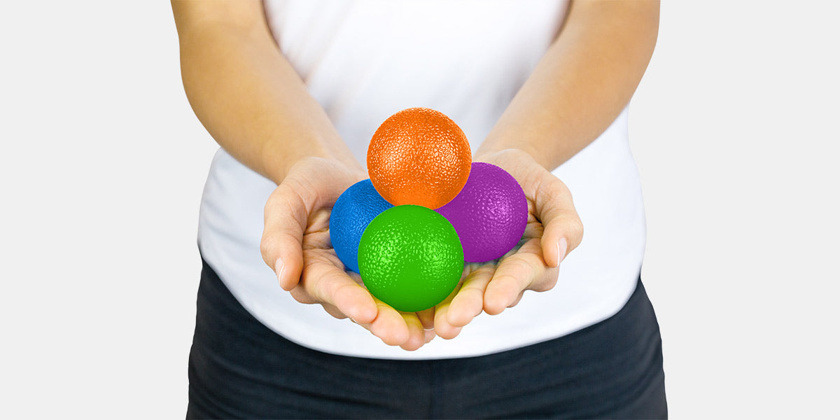 Woman in white shirt holding a exercise balls