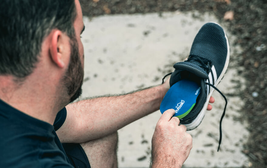 Man inserting shoe insole