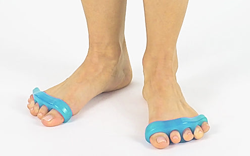 woman's feet wearing toe separators while standing