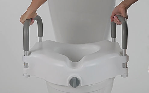 person installing raised toilet seat