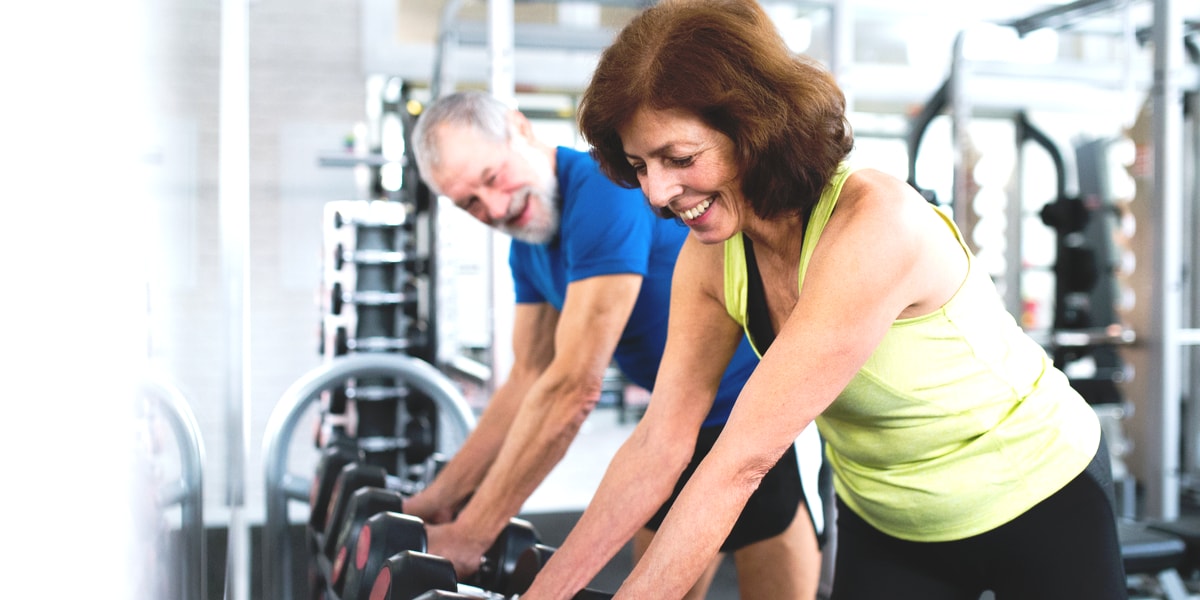 Senior couple in gym working out