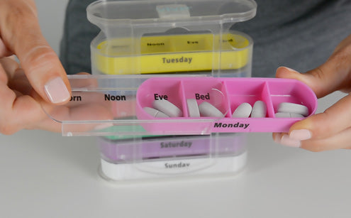 Pill box with spill-proof lids