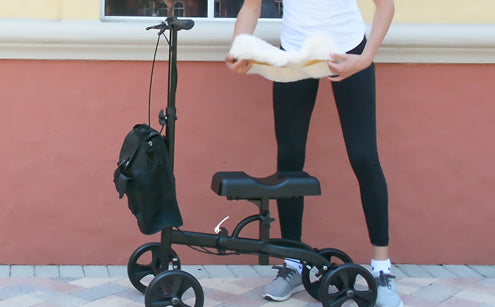 Woman inserting knee pad cover to the knee walker