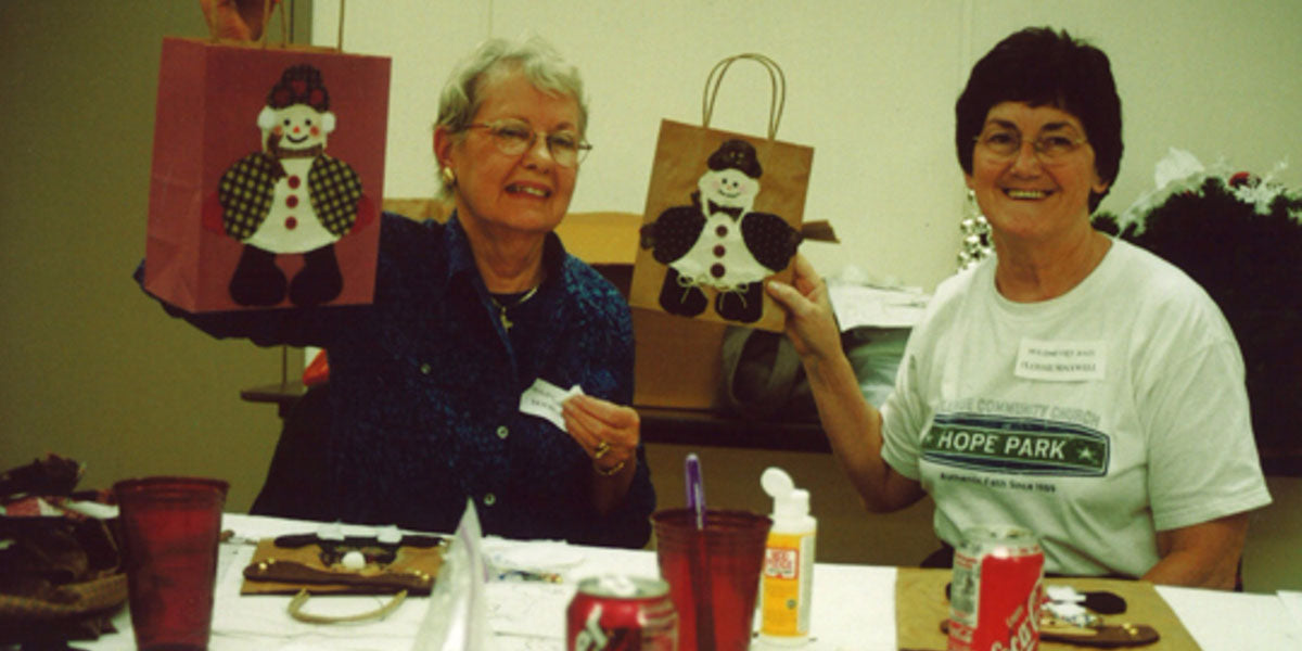 two women making gift bags