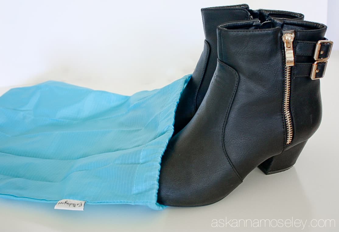 A pair of boots in a travel shoe bag