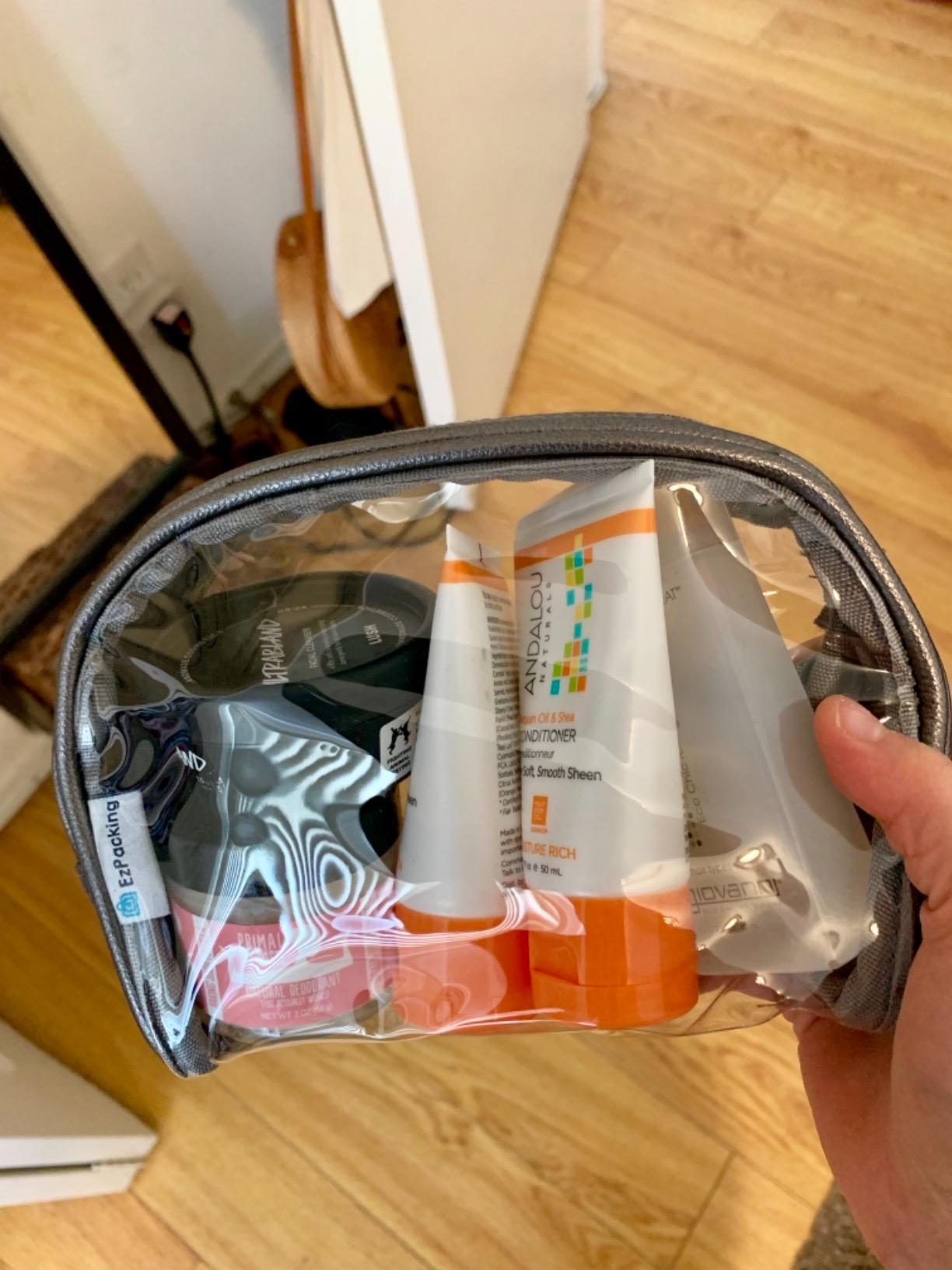 Travel hygiene kit in a clear half moon pouch