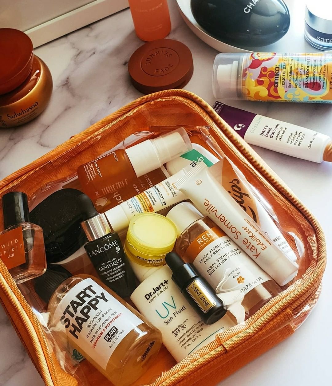 Travel size bottles packed in an orange TSA Approved Toiletry Bag