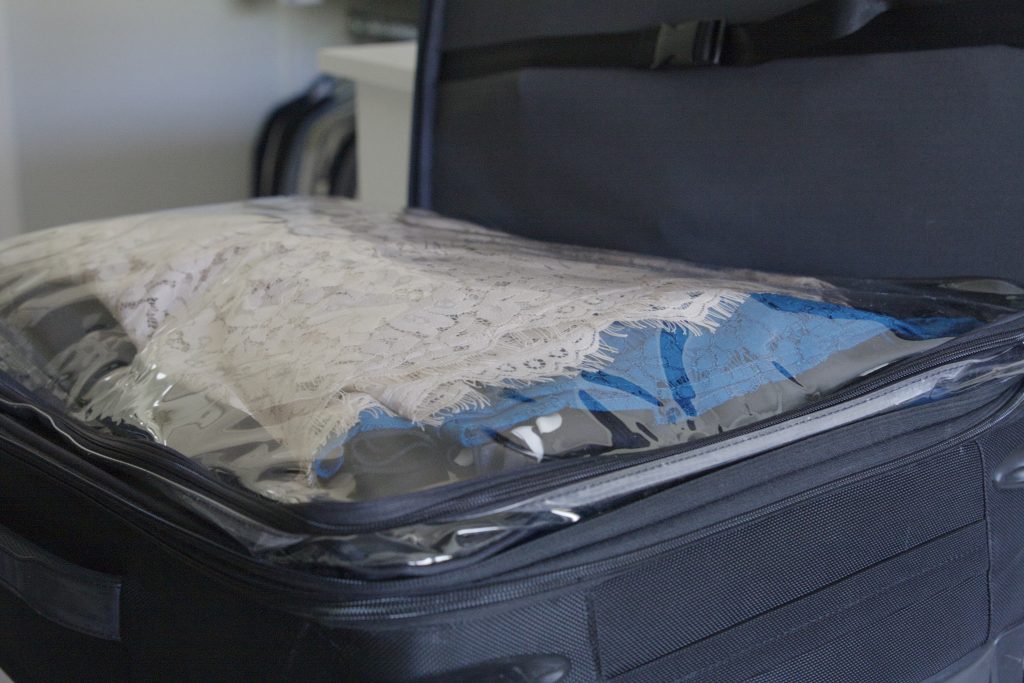 Clothes packed in packing cubes inside suitcase