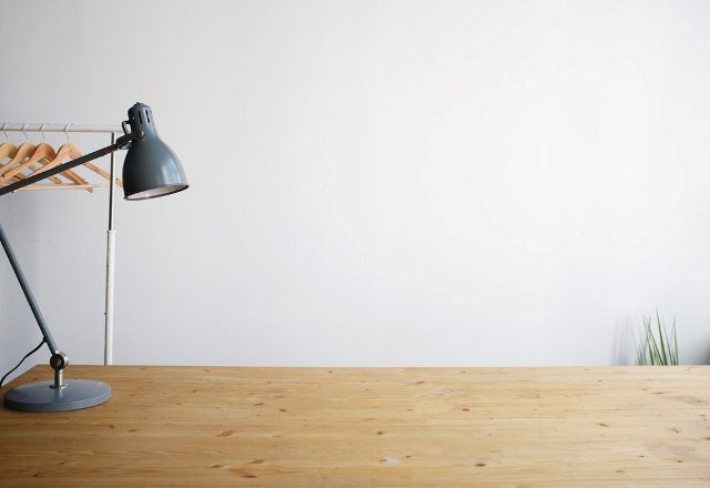 Desk lamp on study table in dorm room