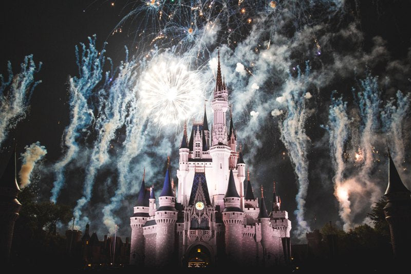 Disneyland castle with fireworks on background