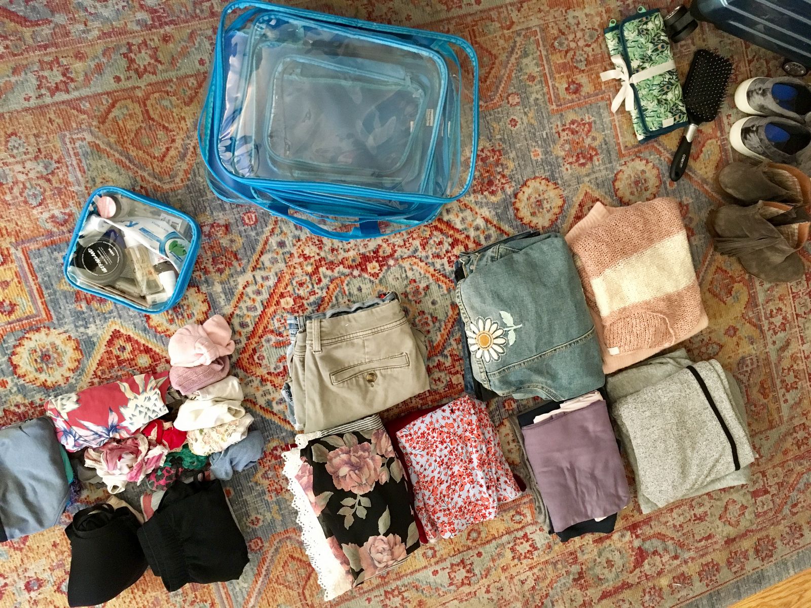 Folded clothes and packing cubes on the floor