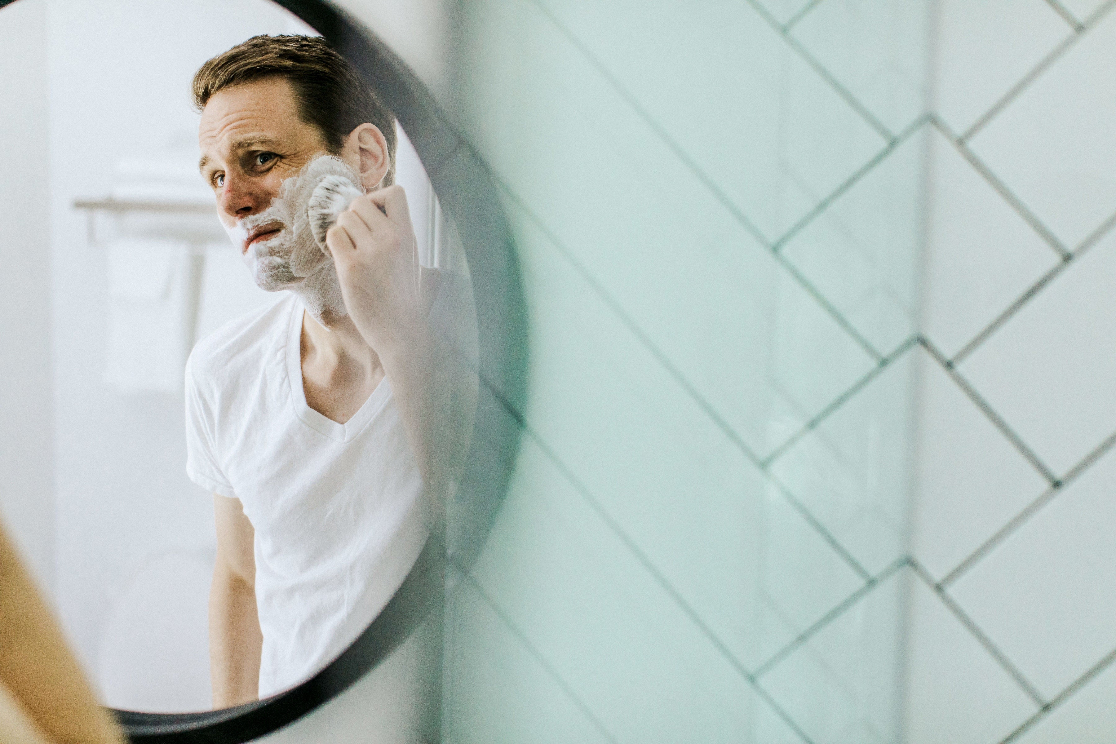 Man shaving in front of the mirror