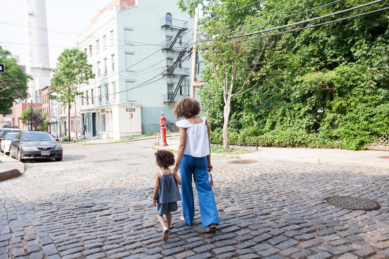 Mommy walking with daughter while on trip