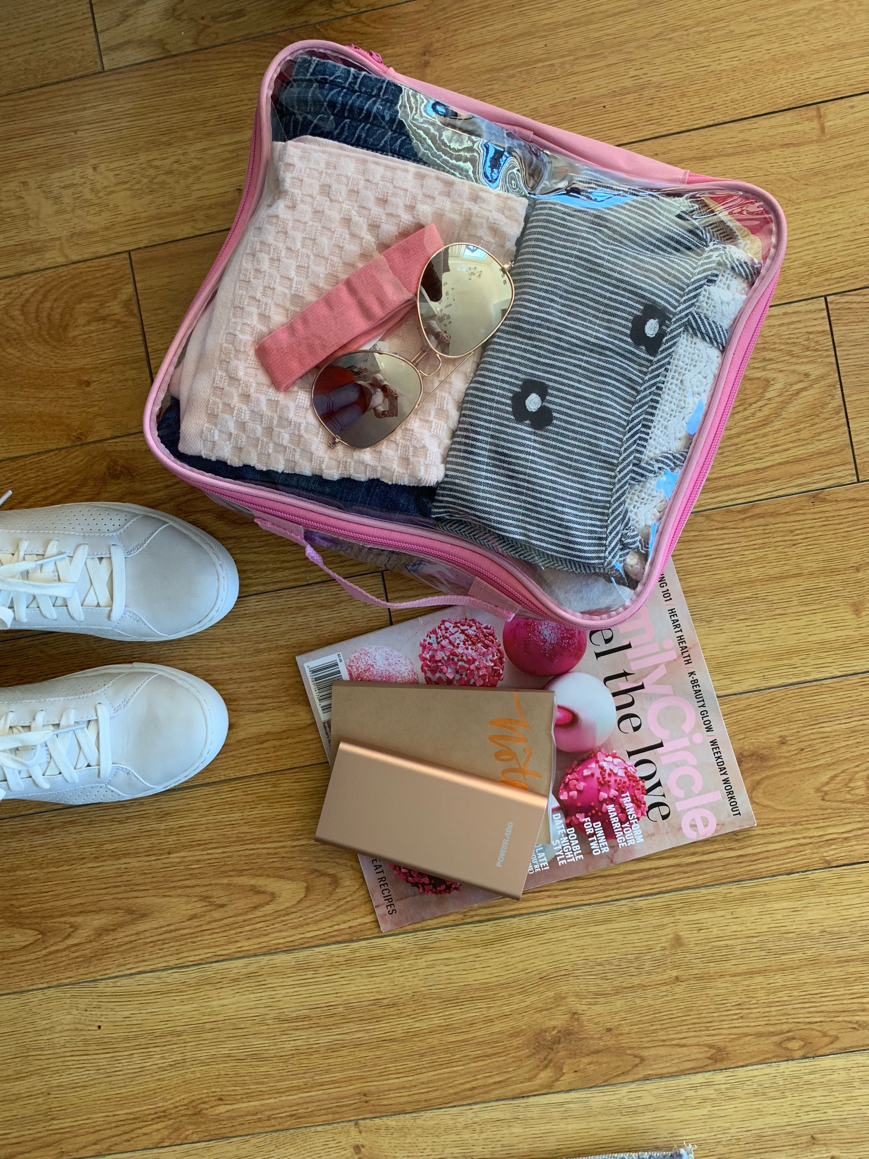 Travel essentials in a pink medium cube