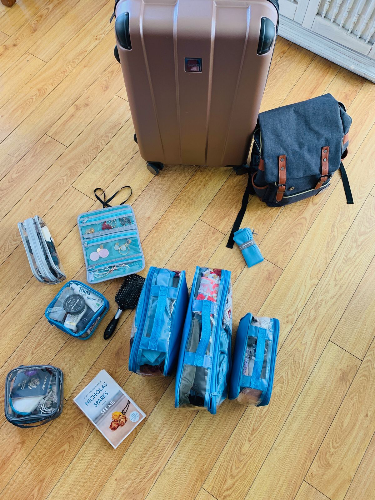 Suitcase, backpack, and other travel items on the floor