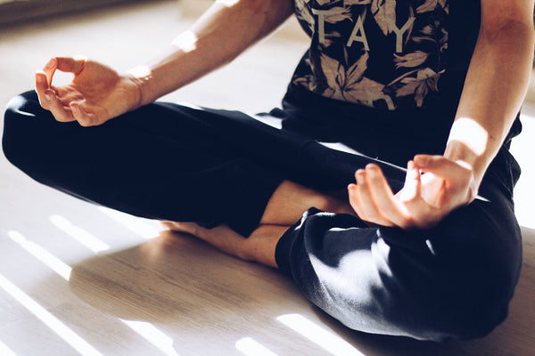 Sitting cross legged and meditating to find a sense of center and grouding. 