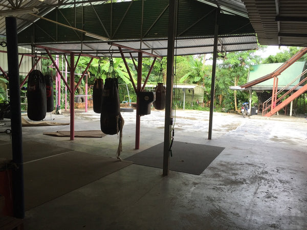Suwit Muay Thai Training Camp and Gym (Chalong) Half indoor half outdoor gym with punching bags