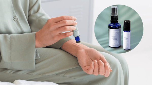 Pewrson applying the Putnams Apothecary Sleep Body Oil to their wrist wearing olive green pyjamas