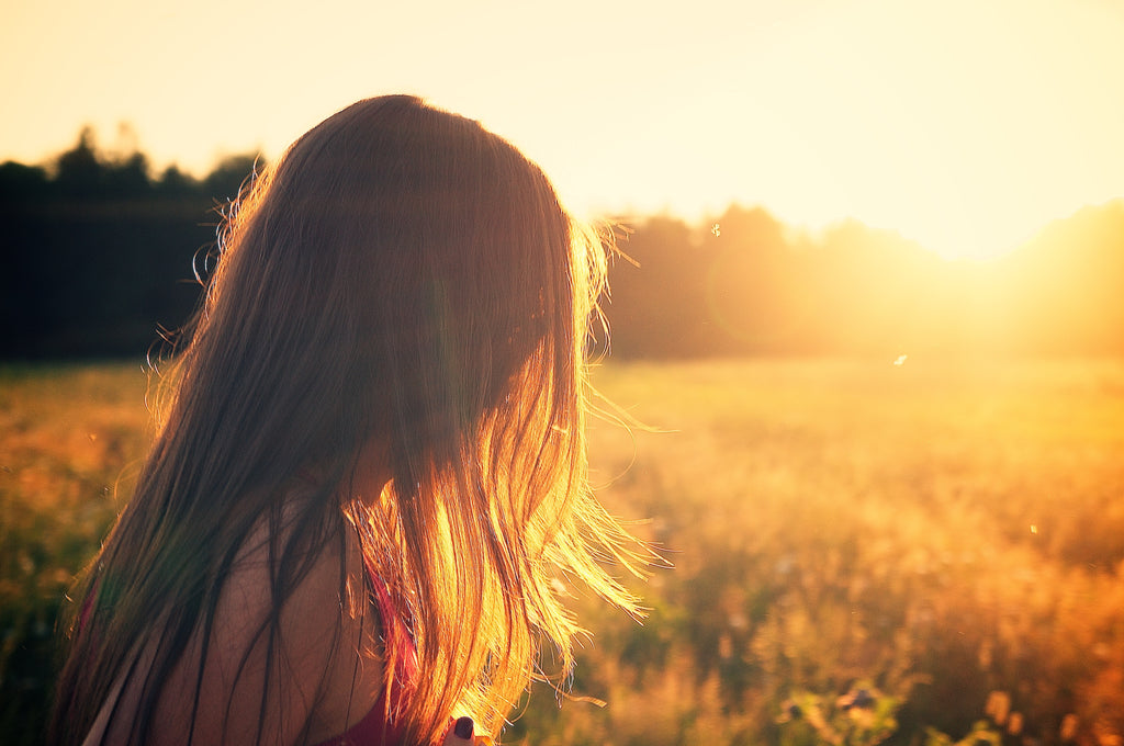 Person looking out into the sunshine across a wheat field trying to cope with Seasonal Affective Disorder SAD by upping their intake of natural vitamin D