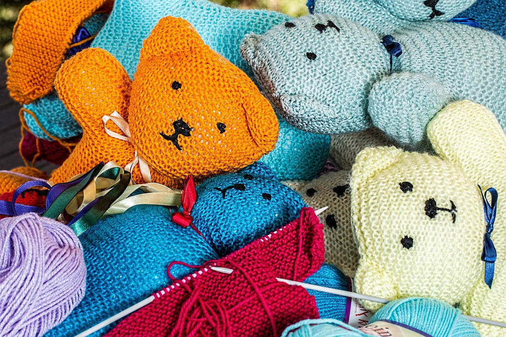 Multicoloured hand knitted teddy bears