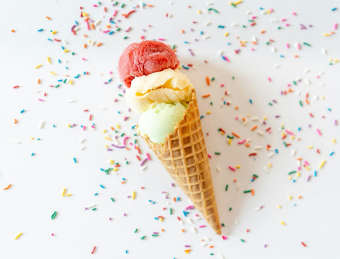 Ice cream cone with scattered sprinkles on the table