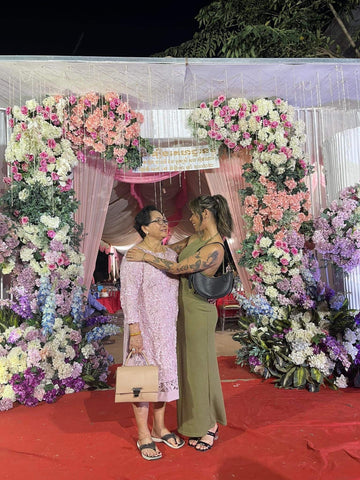 Allisa at traditional wedding in front of huge flower backdrop