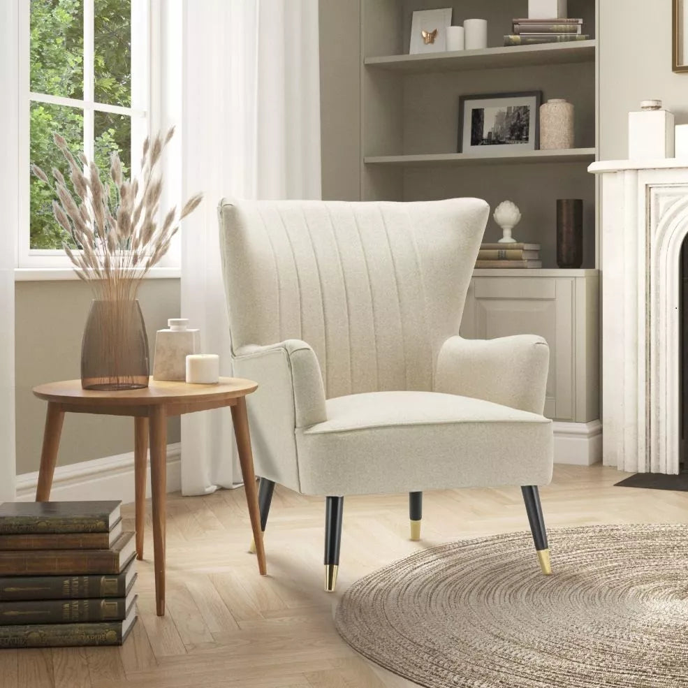 Beige linen Camila chair from stunning chairs on a scandinavian-inspired light background, nexzt to a light wooden coffee table