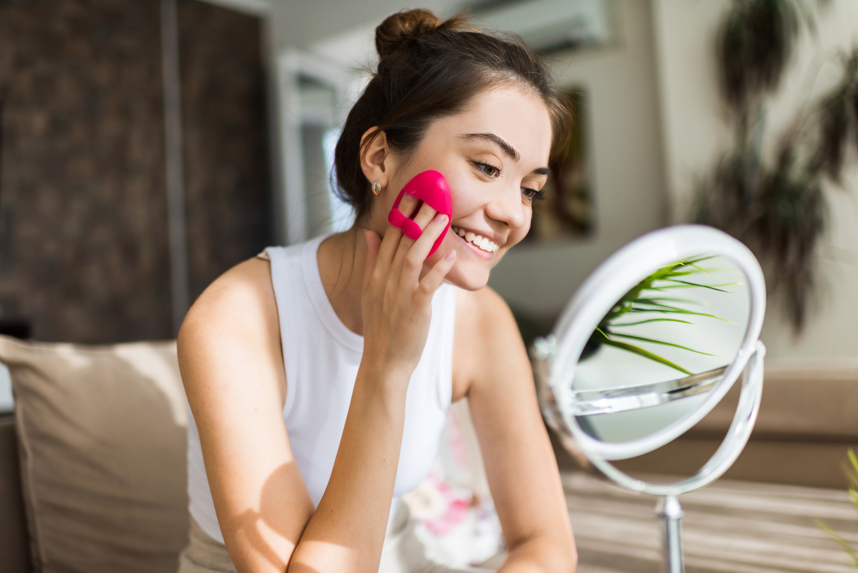 young-caucasian-smiling-woman-is-doing-facial-massage-looking-mirror_1