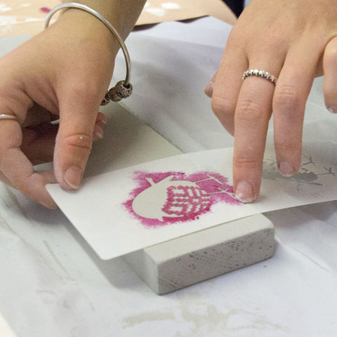 Placing the robin stencil ready to paint, Christmas tree workshop at The Stencil Studio Ltd