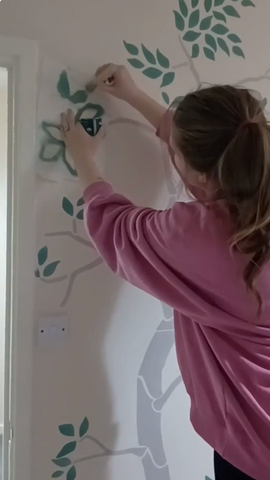 Adding the leaves to the Tree Stencil decorating child's bedroom
