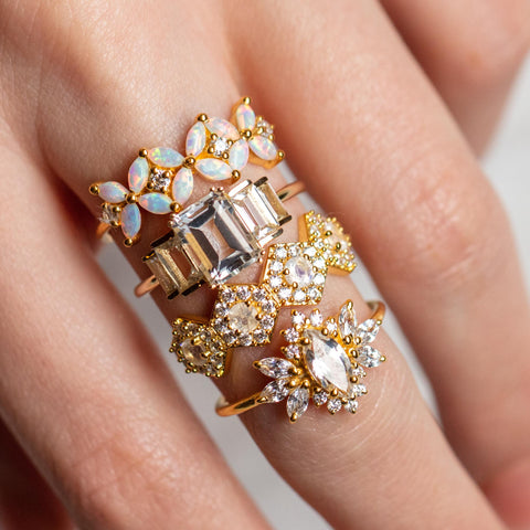 unique cocktail rings with topaz and opal on a finger