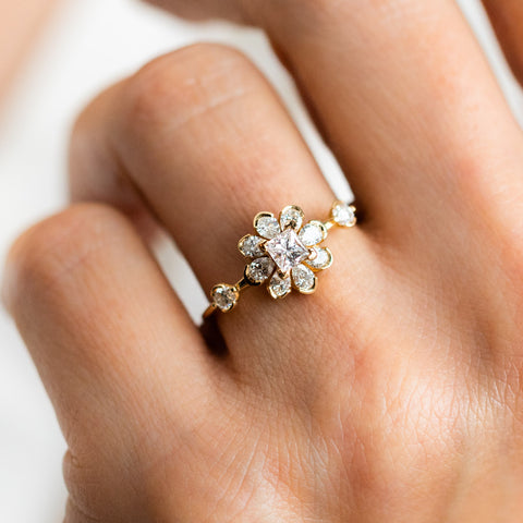 unique flower diamond engagement ring on a hand