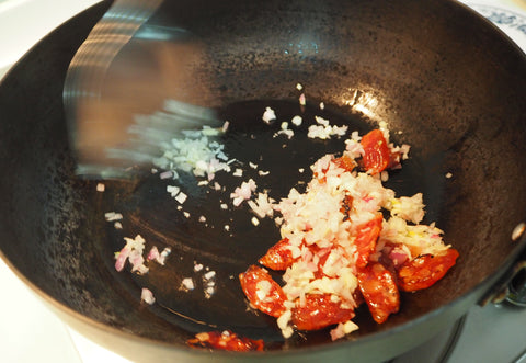 Adding Paella Ingredients