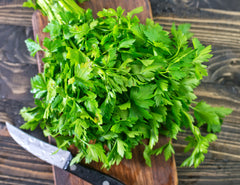 picture of bunch of parsley on cutting board.