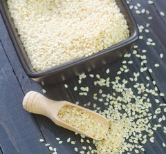 bowl of sesame seeds on dark counter