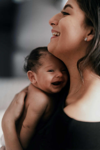 mother holding baby tips for breastfeeding