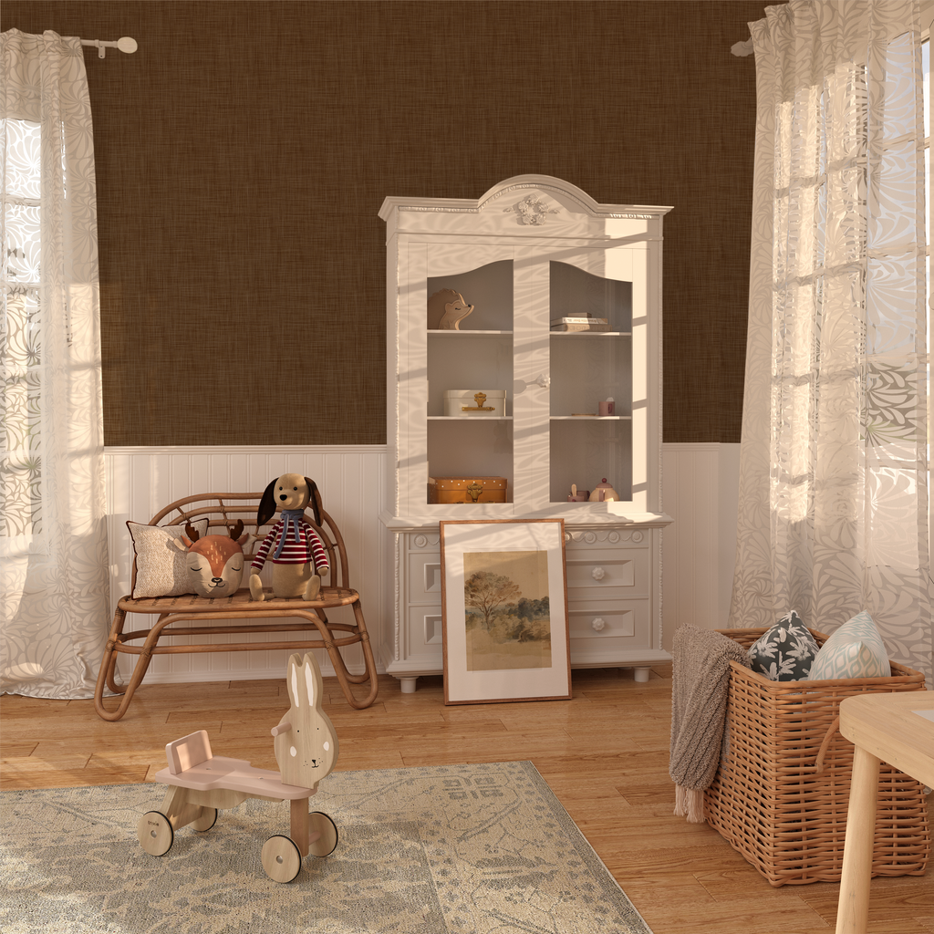 A cozy corner with brown grasscloth peel and stick wallpaper, adding warmth to the white furniture and playful children's toys