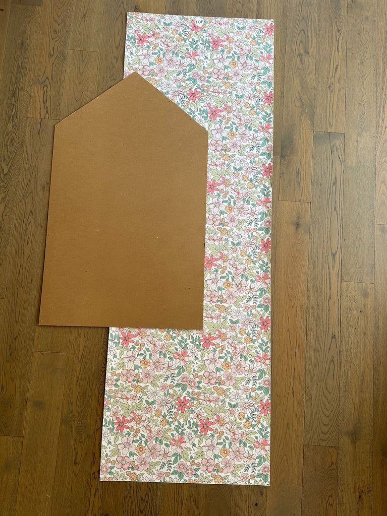 Plywood dollhouse backing 24 inches wide next to peel and stick floral wallpaper