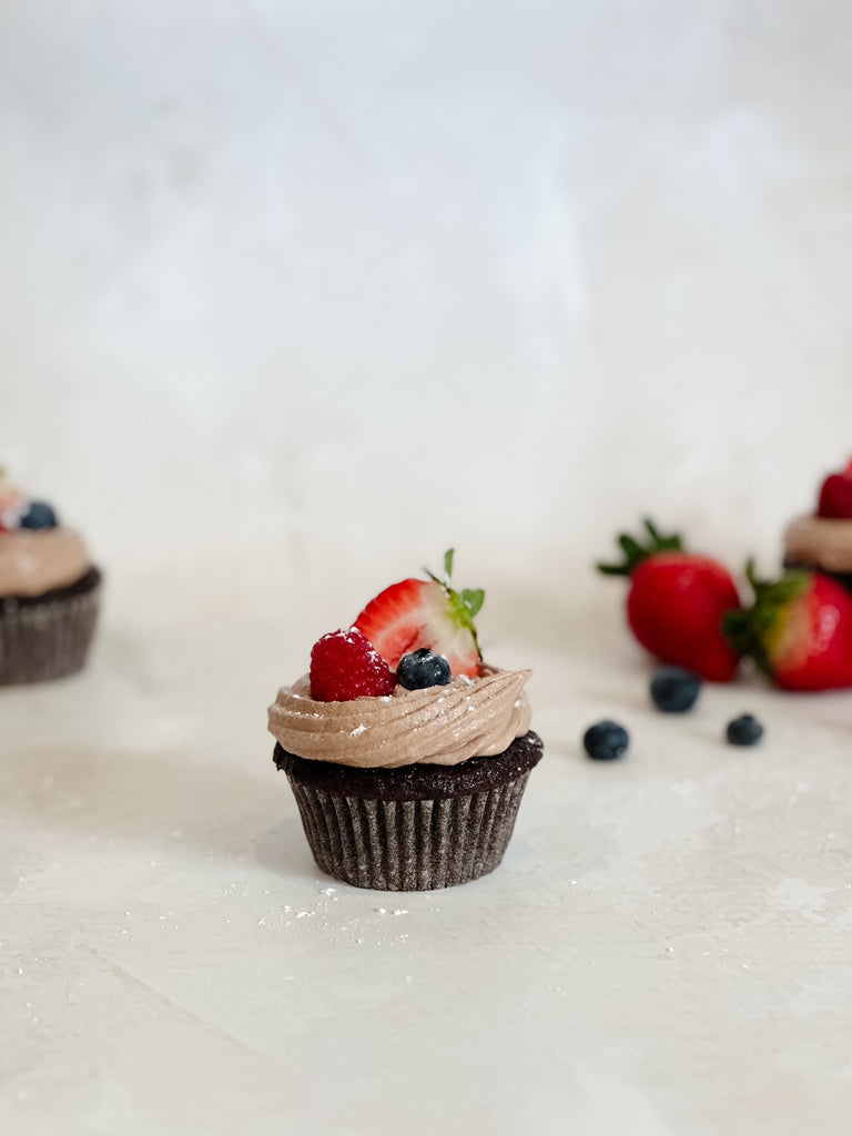 Chocolate cupcake with swiss meringue buttercream topped with fresh fruit for valentines day