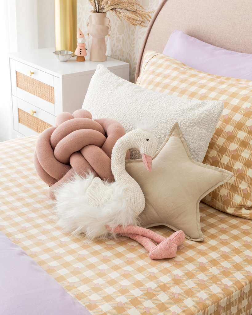 Cushions and Pillow throws on a bed with purple and yellow tones