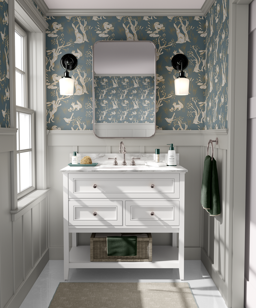 A bathroom with the walls covered in a woodland-themed wallpaper showcasing white rabbits, trees, and birds on a blue background.