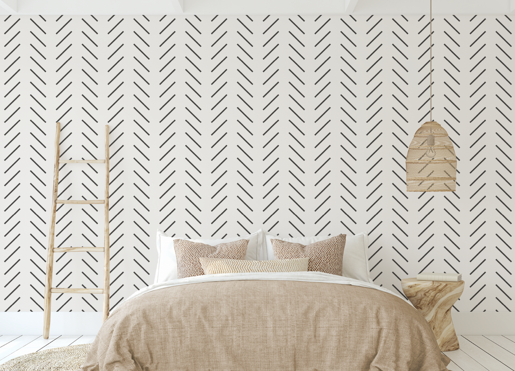 Herringbone white and black peel and stick wallpaper in a comfortable bedroom.