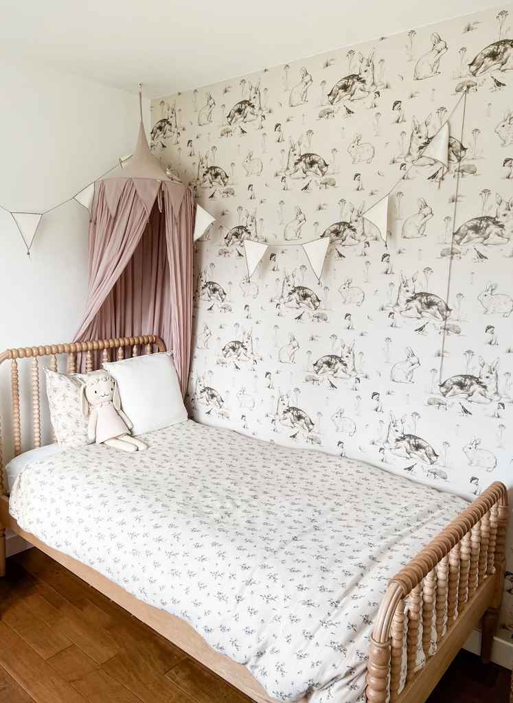 Girls room with deer and bunny peel and stick wallpaper with soft pink accents