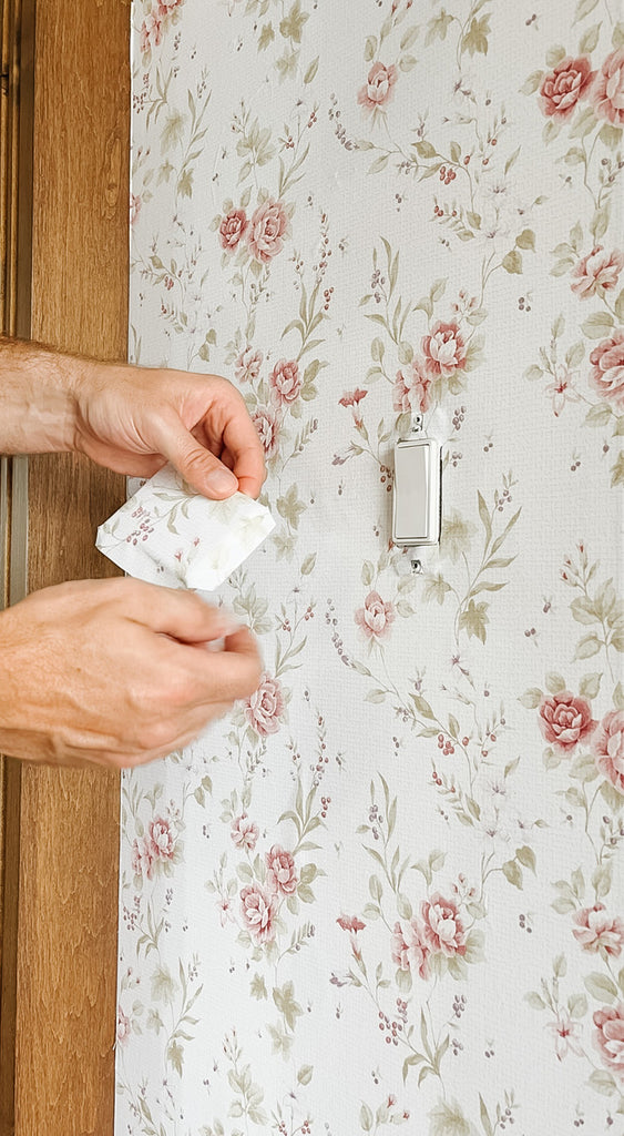 Fold leftover wallpaper over light switch cover for an extra beautiful space