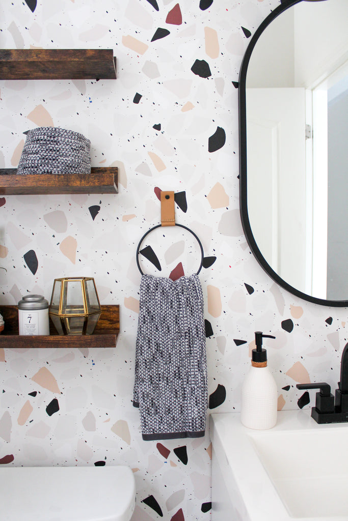 Powder room inspo using wallpaper and black and white accents