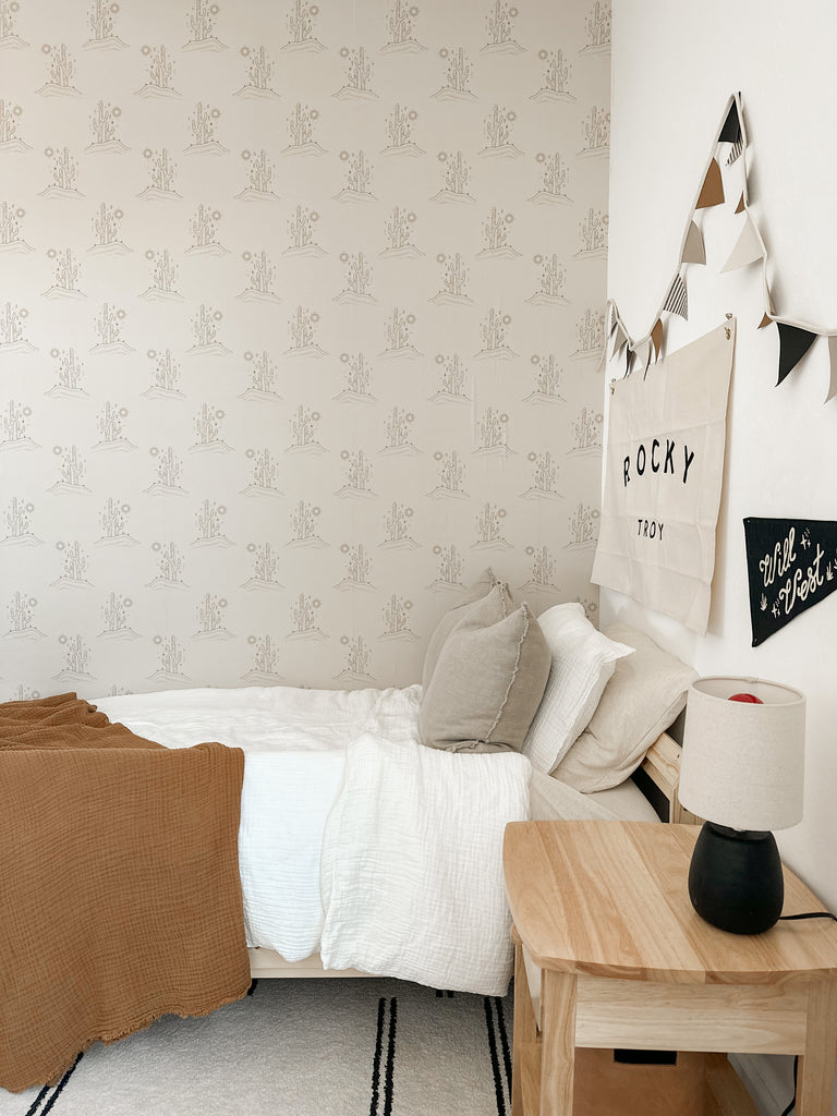 Clean looking childs room with damage free wallpaper with western desert cactus design