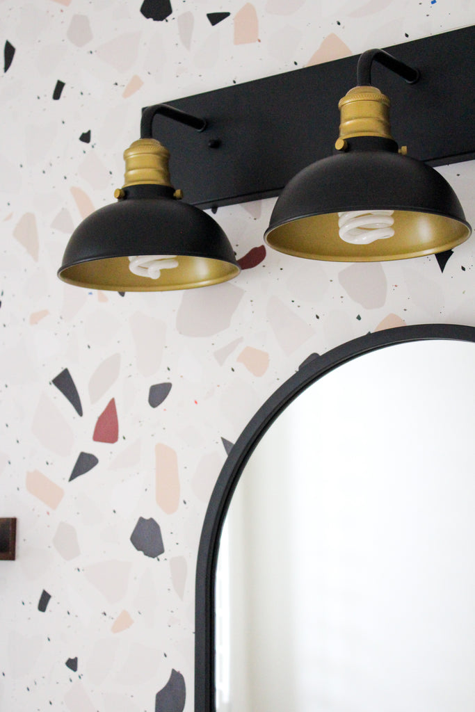 Aesthetic bathroom with black accents and terrazzo wallpaper